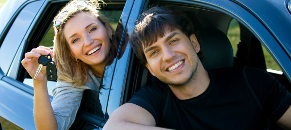 happy couple riding a car