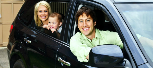 happy family posing inside their brand new car
