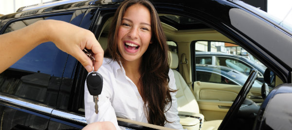 enthusiastic woman receiving her new car keys