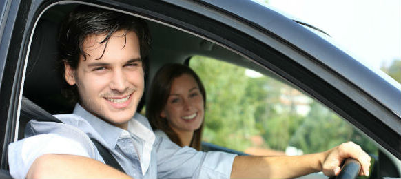 cheerful couple driving car 