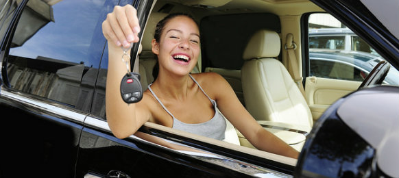 happy woman showing off her car key