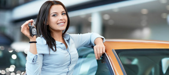 woman standing beside a car